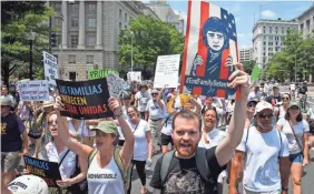  ?? JACK GRUBER/USA TODAY ?? Protesters march Saturday during the Families Belong Together rally in Washington in response to immigratio­n policies that have separated parents from their children on the U.S.-Mexican border.