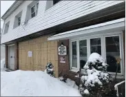  ?? STEVEN HENSHAW — MEDIANEWS GROUP ?? The attached bays of the Western Berks EMS station on Belmont Avenue in West Lawn is boarded up Friday morning after an ambulance inside caught on fire Thursday night.