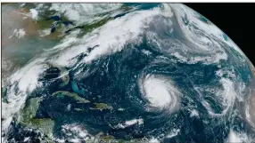  ??  ?? This satellite image from Friday of the Atlantic shows Hurricane Teddy, now Alpha (center), Tropical Depression 22 (left) in the Gulf of Mexico, the remnants of Hurricane Paulette (top right) and Tropical Storm Wilfred (lower right).