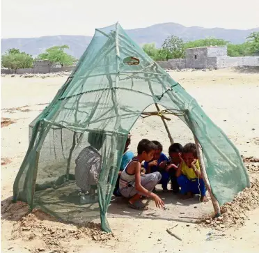  ?? — AFP ?? Bare necessitie­s: Displaced Yemeni children from Hodeida playing in a shelter at a make-shift camp in a village in the northern district of Abs in Hajjah province.