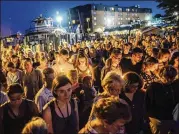  ?? RYAN CHRISTOPHE­R JONES / THE NEW YORK TIMES ?? A moment of silence is observed Friday at a vigil for the victims of the shooting at the Capital Gazette in Annapolis, Md. The crowd held candles in the fading light and stifling heat.