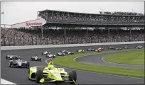  ?? DARRON CUMMINGS — ASSOCIATED PRESS FILE ?? In this May 26, 2019, file photo, Simon Pagenaud, of France, leads the field through the first turn on the start of the Indianapol­is 500IndyCar auto race