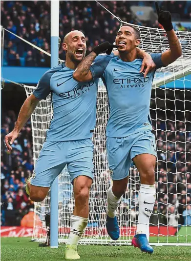  ??  ?? Hot in the City: Manchester City’s Gabriel Jesus (right) celebratin­g with Pablo Zabaleta after scoring the winning goal against Swansea in the English Premier League match at the Etihad on Sunday. — AFP