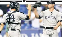  ?? AP ?? SAVING THE DAY: Zach Britton celebrates with Gary Sanchez after collecting his third save as a Yankee.