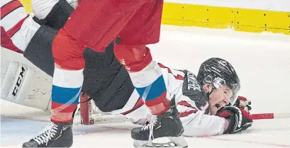  ?? RYAN REMIORZ THE CANADIAN PRESS ?? Canadian star Alexis Lafrenière, upended by Russia's Yegor Zamula, left Saturday’s world junior game with a left knee injury.