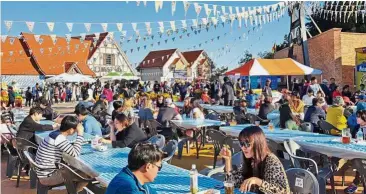  ??  ?? Cultural exchange: Madam Suk helped to start an annual beer festival, modelled after the German beer festival Oktoberfes­t, in Dogil Maeul. — The Straits Times/ANN