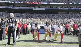  ?? TED S. WARREN / ASSOCIATED PRESS ?? San Francisco 49ers players Eli Harold (58), Colin Kaepernick (7) and Eric Reid (35) kneel during the national anthem before an NFL football game against the Seattle Seahawks on Sunday in Seattle.