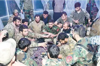  ?? SAMI SADAT ?? An undated photo shows Akmal Amir and soldiers in Afghanista­n’s Helmand province after a 2021 night operation.