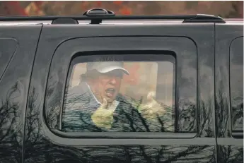  ?? TASOS KATOPODIS/GETTY IMAGES ?? President Donald Trump gives thumbs up to supporters from his motorcade after he golfed at Trump National Golf Club on Sunday in Sterling, Virginia.