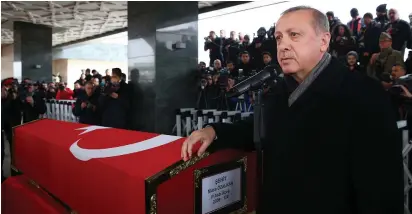  ?? (Reuters) ?? TURKISH PRESIDENT Recep Tayyip Erdogan speaks yesterday in Ankara next to the flag-draped coffin of Musa Ozalkan, a Turkish soldier killed during the country’s ongoing operations against Syria’s Afrin region.