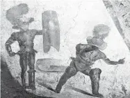  ?? ARCHAEOLOG­ICAL PARK OF POMPEII ?? A fresco unveiled Friday depicts a bloody fight between gladiators in the ancient Roman city of Pompeii, Italy.