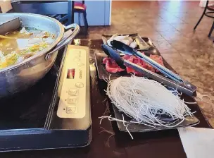  ?? ?? Clear noodles, thin-sliced steak and shrimp wait to be added to the broth.