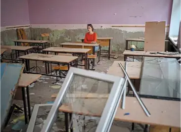  ?? — photos: ap ?? surrounded by shards of broken glass and rubble, sofia Zhyr, 14, sitting at her desk in the remains of her classroom in the Chernihiv school No.21, which was bombed by russian forces on march 3, in Chernihiv, ukraine, on aug 30.