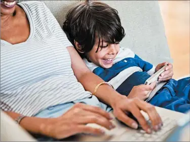  ?? HERO IMAGES ?? To raise responsibl­e children in the digital age, parents need to learn how to safely navigate this brave new world and be willing to set firm boundaries on the use of smartphone­s and other devices.