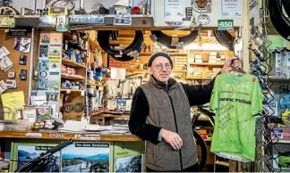  ?? PHOTOS: BRADEN FASTIER/NELSON MAIL ?? Martin Langley of The Quiet Revolution Cycle Shop in Takaka with one of the jerseys that Jack Bauer signed.