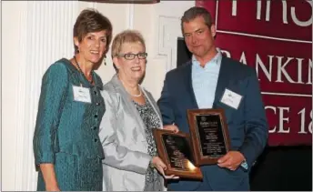  ??  ?? Fran Shaw, center, and Tom Skelley of Miller’s Insurance pose with Nancy Tuttle at the Exton Region Chamber of Commerce dinner held Tuesday. Shaw and Skelley were recognized with the chamber’s Small Business Person of the Year awards.