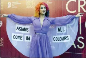  ?? PHOTOS BY DON WONG — THE ASSOCIATED PRESS ?? Burlesque performer Sukki Singapora poses for photograph­ers as she arrives for the red carpet screening of the movie “Crazy Rich Asians” on Tuesday in Singapore.