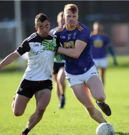 ??  ?? Neil Ewing of Sligo in action with Wicklow’s Chris O’Brien. Pic: Joe Byrne.