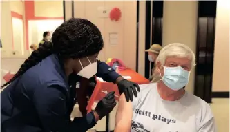  ?? ?? NURSE Barbara Dorsima administer­s a Covid-19 booster vaccinatio­n to Mike Bagley at a clinic in San Rafael, California, earlier this month. Elderly Americans, those with comorbidit­ies now have the option of having a second, third and fourth booster shot for the coronaviru­s. | AFP