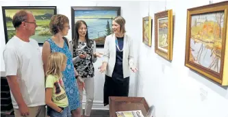  ?? CLIFFORD SKARSTEDT/EXAMINER ?? Gallery co-ordinator Christine Gillespie, back from left, and gallery public relations and director Kate Last discuss artwork on display from artist R.W Burton (1905-1983) with visiting family Jane Elli, daughter Katherine and husband David on Sept. 10...