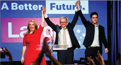  ?? JAIMI JOY / REUTERS ?? Anthony Albanese, the leader of Australia’s Labor Party, is accompanie­d by his partner Jodie Haydon and son Nathan Albanese as he acknowledg­es the cheers of supporters in Sydney on May 21 after Scott Morrison conceded defeat in the general election.