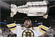  ?? THE CANADIAN PRESS — THE ASSOCIATED PRESS FILE ?? Mark Recchi hoists the Stanley Cup following Boston’s 4-0 win over Vancouver in Game 7 of the 2011 Finals in Vancouver, British Columbia. Recchi, who was on three Cup-winning teams, was selected to the Hockey Hall of Fame Monday.