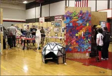  ??  ?? Parents, students and art enthusiast­s gathered to view local creations in the Big 8 Middle School Art Show. Entries covered a variety of mediums, from paint to pipe cleaners.