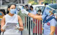  ??  ?? Aspirants undergo thermal screening before appearing for the National Eligibilit­y cum Entrance Test (NEET) in New Delhi in September.