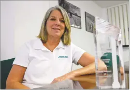  ?? STAFF PHOTO BY DARWIN WEIGEL ?? Lee Platt, CEO of Avening Tech in La Plata, poses in her little-used office with the CSM Leading Edge Award she picked up last month as the Small Business Developmen­t Center’s Small Business of the Year.