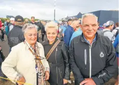  ??  ?? Darren Clarke’s mum Hatty, dad Godfrey and sister Andrea watch as he plays in the first round of The Open, and (below) US fans walk the course during day one of The Open Championsh­ip at Royal Portrush