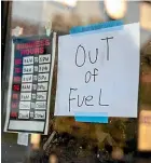  ?? AP ?? A sign in the window of a petrol station in Lynchburg, Virginia, gives drivers the bad news.