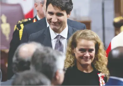  ?? SEAN KILPATRICK / THE CANADIAN PRESS FILES ?? Prime Minister Justin Trudeau follows Gov. Gen. Julie Payette as she leaves the Senate Chamber following the throne
speech late in 2019. A conspiracy by both offices could keep a rogue PM in office unwarrante­dly.