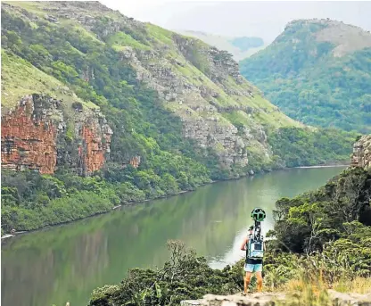  ?? /Supplied ?? Taking it in: Gary the Google Trekker, seen here with one of its human porters, has captured some of SA’s most beautiful trails in a bid to entice tourists to experience the scenery and walks for themselves.