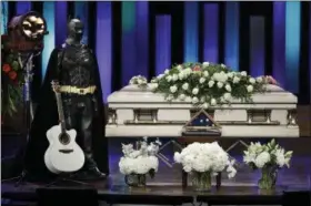  ?? MARK HUMPHREY — THE ASSOCIATED PRESS ?? A Batman costume and guitar stand next to the casket during a memorial service for country music singer Troy Gentry at the Grand Ole Opry House Thursday in Nashville, Tenn. Gentry, who was a fan of Batman and made up the duo Montgomery Gentry with...