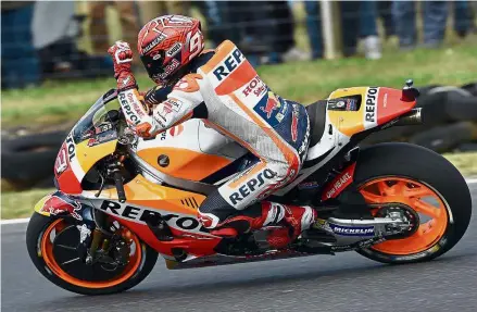 ?? — AFP ?? Fast and furious: Honda rider Marc Marquez of Spain celebratin­g his pole position during the qualifying session of the Australian MotoGP at Phillip Island yesterday.