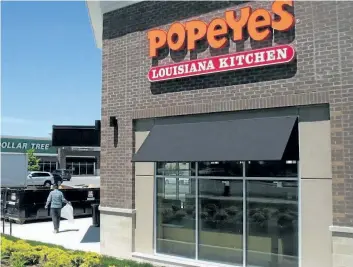  ?? DOUG IVES/ THE CANADIAN PRESS ?? A Popeyes Louisiana Kitchen restaurant in Bowmanvill­e, Ont., on June 3, 2017. Restaurant Brands Internatio­nalInc., which owns Popeyes and Tim Hortons, reported a better- than- expected profit for its fourth quarter as revenue improved more than 10 per cent compared with year earlier.