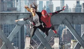  ?? Matt Kennedy/Sony Pictures / TNS ?? MJ (Zendaya) and Spider-Man (Tom Holland) jump off a bridge in “Spider-Man: No Way Home.”