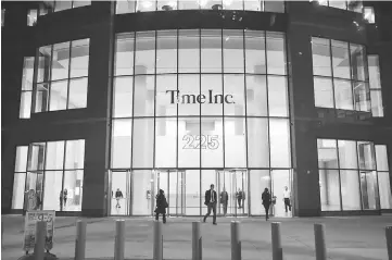  ??  ?? Pedestrian­s walk past the new headquarte­rs of Time Inc. in New York, on Oct 27, 2015. — WP-Bloomberg photo