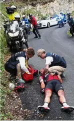  ??  ?? Needing help: Australia’s Richie Porte gets medical assistance after crashing in the descent of the Mont du Chat pass during the ninth stage of the Tour de France on Sunday.