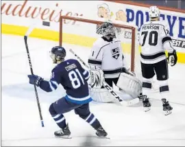  ?? Trevor Hagan Associated Press ?? KYLE CONNOR scores past Kings goaltender Jack Campbell to lift Winnipeg in overtime as Tanner Pearson looks away. Connor also scored in the second period.