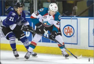  ??  ?? Nolan Foote of the Kelowna Rockets battles Carter Folk of the Victoria Royals for the puck in WHL action Friday night at Prospera Place in Kelowna. Victoria won 2-1.