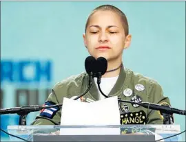  ?? Chip Somodevill­a Getty Images ?? EMMA GONZALEZ observes a period of silence before the crowd in Washington, marking the time it took a shooter to kill 17 at her high school in Parkland, Fla.