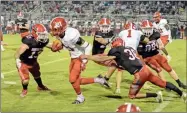  ?? Adam dortch ?? Jebb Knight (13) and Mason Walker (36) bring down LFO wideout Trevon Gott as part of a stifling defensive effort for the Phoenix.