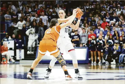  ?? M. Anthony Nesmith / Icon Sportswire via Getty Images ?? UConn’s Nika Muhl (10) is defended by Texas’ Shaylee Gonzales (2) on Monday.