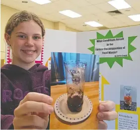  ?? PHOTOS: SCOTT DUNN/POSTMEDIA NETWORK ?? Stella Gowan, 12, of Kincardine found putting cola into compost helps it decay faster, a science fair project she presented, April 10 in Owen Sound.