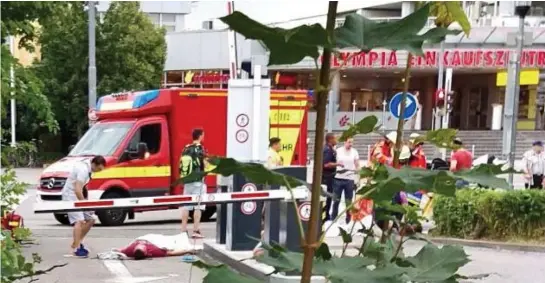  ??  ?? Aftermath: Emergency services arrive outside the Olympia shopping centre to find a scene of horror with casualties on the ground