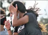  ?? Signal file photo ?? A young woman holds onto her hair as strong winds blow in Santa Clarita on Wednesday. Following the rain Sunday and Monday, cold weather and strong winds are forecast in the SCV, beginning today.