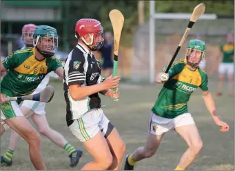  ??  ?? GavinWatch­orn about to strike for Hollow Rovers in their Under-20 win in Farmleigh onWednesda­y despite the best efforts of HWH-Bunclody duo John Dunne and Jamie Kavanagh.