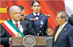  ?? EDUARDO VERDUGO/ASSOCIATED PRESS ?? Mexico’s new President Andrés Manuel López Obrador, left, receives the presidenti­al sash Saturday from Porfirio Munoz Ledo, president of the Congress, during the inaugural ceremony in Mexico City.