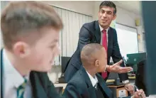  ?? AP-Yonhap ?? Britain’s Prime Minister Rishi Sunak meets students taking part in a personal developmen­t lesson in Darlington, Jan. 29, as he visits Haughton Academy to outline plans for the banning of single-use vapes.